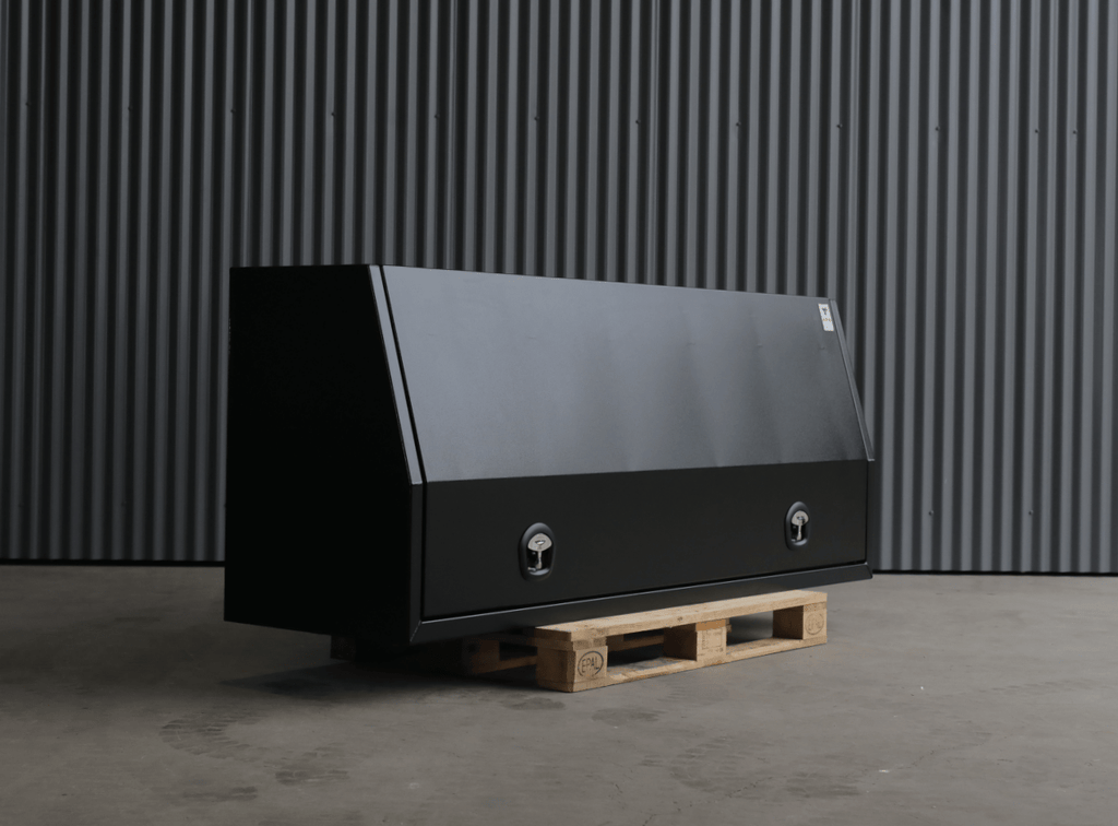 Apboxes 2100mm black 3-drawer gullwing toolbox, closed and set against a corrugated wall.