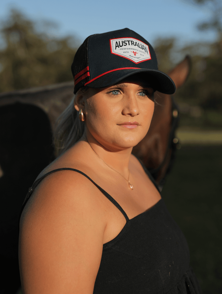 Woman wearing the apboxes navy trucker hat