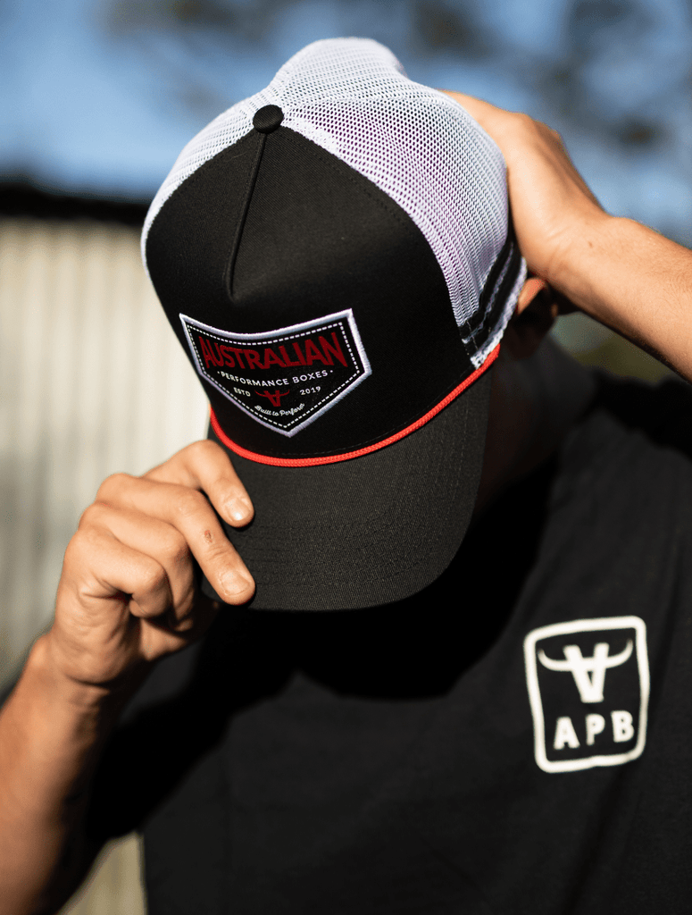 Man wearing the apboxes black trucker hat