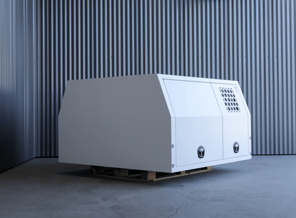 Apboxes lc79 1700mm full dog box canopy in white, rear and side view sat on a warehouse floor.